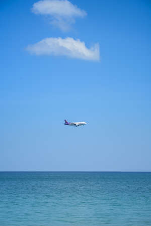 plane on  blue sky and seaの写真素材