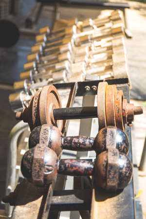 Rows of metal dumbbells on rack in the gym,Weight Training Equipment.の写真素材