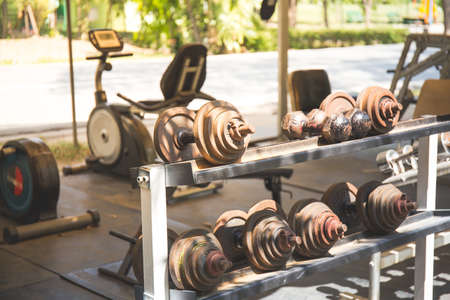 Rows of metal dumbbells on rack in the gym,Weight Training Equipment.の写真素材