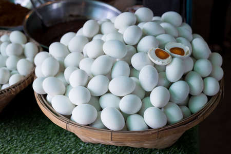 Salted eggs in a basket on the market.の写真素材