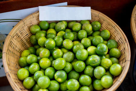 Green-Lemons  in the basketの写真素材