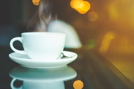 cup of coffee and smoke on table in cafe,Soft focusの写真素材