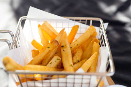 French fries in a metal basket.の写真素材