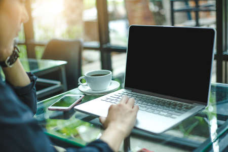 Women work with Computer screen blank on the table, have coffee and telephone
 in the office.Soft focusのeditorial素材