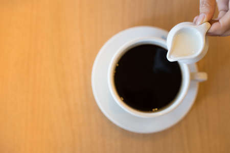 Sweetened condensed milk on coffeeの写真素材