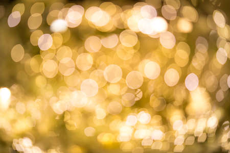 blurred lights with bokeh effect golden backgroundの写真素材