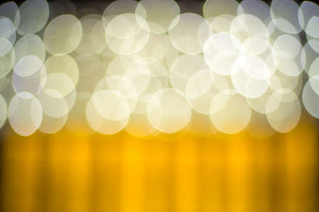 blurred lights with bokeh effect golden backgroundの写真素材
