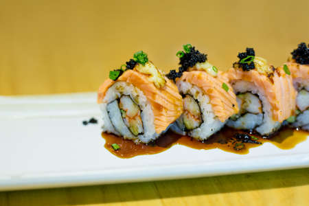 grilled salmon sushi roll on a white plate.japanese food styleの写真素材