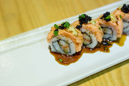 grilled salmon sushi roll on a white plate.japanese food styleの写真素材