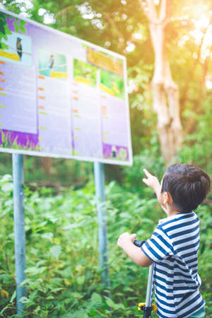 Boy is learning bird name sign in Bangkajao Parks where people like to relax.の写真素材