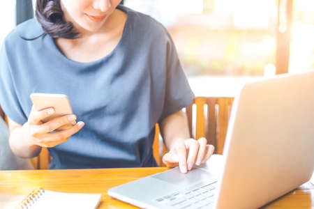 Business woman working in computer and phone at workの写真素材