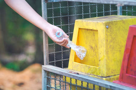 Hand throws a plastic bottle into the bin.Environmental conservation conceptのeditorial素材