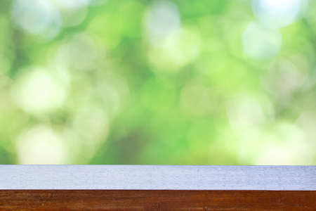 Wood table on the background blurred green nature.Ideal for displaying great products or montage...