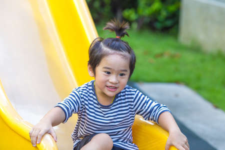 Cute boy playing slider in the playground.の写真素材