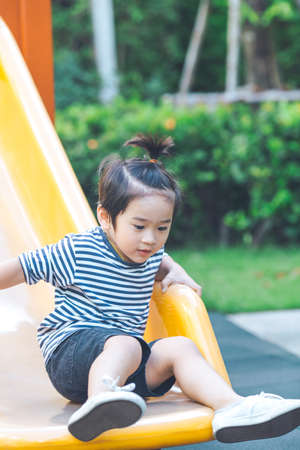 Cute boy is playing slider in playground.の写真素材