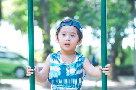 Asian cute boy is playing in the playground.の写真素材