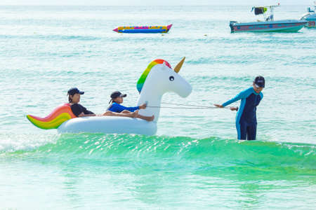 Rayong, THAILAND - October 31 2017 : Happy family playing at the beach.They played with unicorns floating.Tourists on vacation on Koh Samet, Thailandのeditorial素材