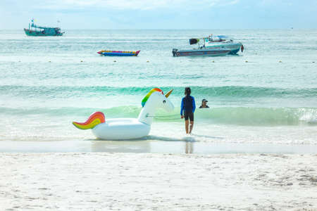 Rayong, THAILAND - October 31 2017 : Happy family playing at the beach.They played with unicorns floating.Tourists on vacation on Koh Samet, Thailandのeditorial素材