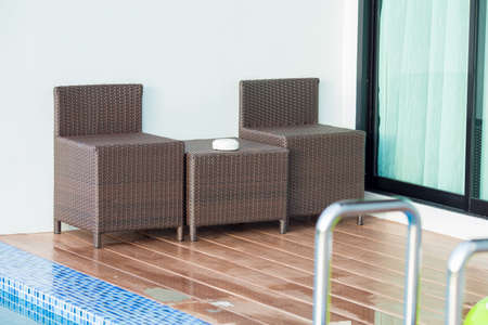 Chair beside the pool. Front of hotelの写真素材