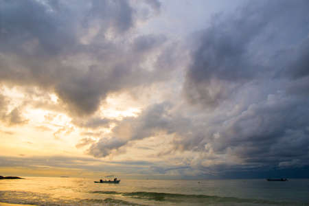 The sky was storm at the beach at sunrise.
