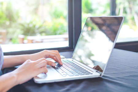 Business woman hand working with a laptop computer in the office.
