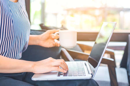 Business woman hand working with a laptop computer in the office.の写真素材