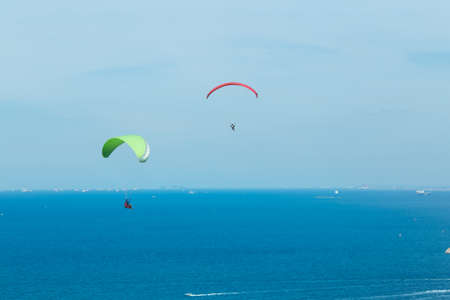 Two Paragliding flying through the sea and beautiful sky, Koh Lan Pattaya Thailandの写真素材