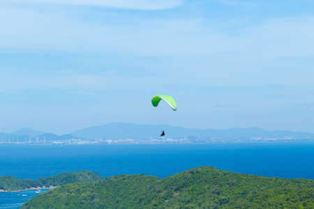 Paragliding flying through the sea and beautiful sky, Koh Lan Pattaya Thailandの写真素材