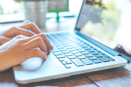 Woman's hand working on laptop in the office.
