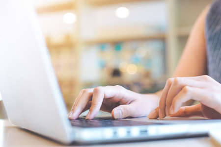 Business woman hand working with a laptop computer in the office.の写真素材
