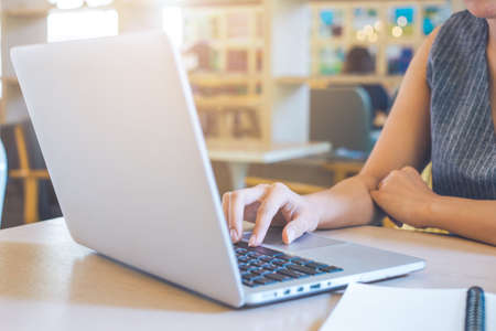 Business woman hand working with a laptop computer in the office.の写真素材