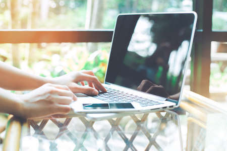 Business woman hand working with a laptop computer in the office.の写真素材