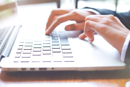 Business woman hand is working on a laptop computer in office.の写真素材