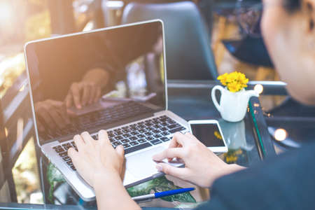 Business women are using a laptop computer in the office.