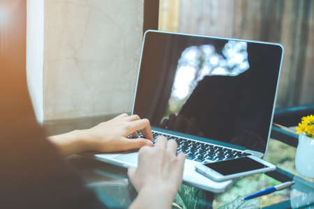 Business women are using a laptop computer in the office.の写真素材