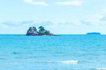 The islands are in the middle of the sea, the sky and the sea with waves.