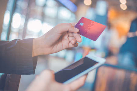 Business woman hand use credit cards and smartphones.の写真素材