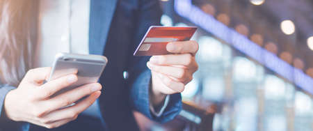 Business woman hand use credit cards and smartphones.Web banner.の写真素材