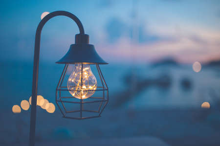 Vintage light bulbs decorated in the living room, sea view at sunset.の写真素材