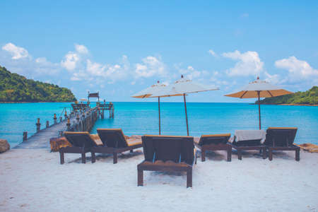 Beach chairs and wooden bridges on Ao Prao Beach, Ko Kood, Trat in sun rise.の写真素材