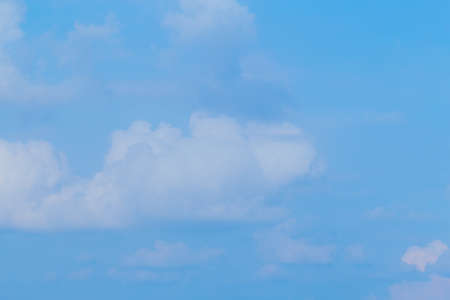 Floating clouds, fluffy colors against the blue sky