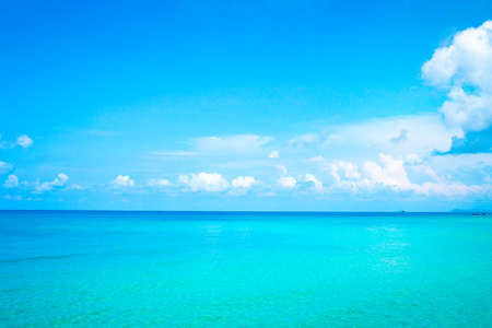 Floating clouds, fluffy colors against the blue sky and the seaの写真素材