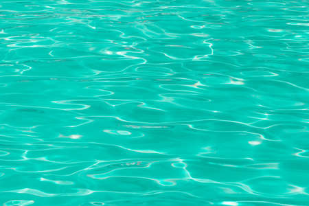 green pool water with sun reflections.の写真素材