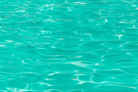 green pool water with sun reflections.の写真素材