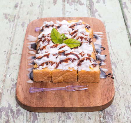 Toast cream is placed on a wooden table.の写真素材