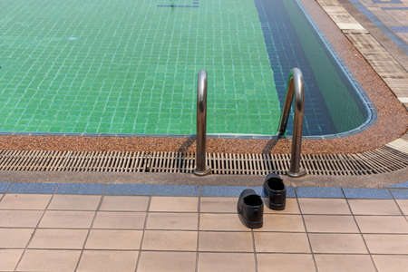 Shoes lying beside the poolの写真素材
