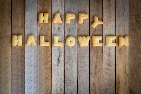Halloween letters of bread on the wooden floor .の写真素材