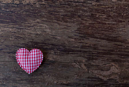 pink hearts placed on the old wooden floorの写真素材