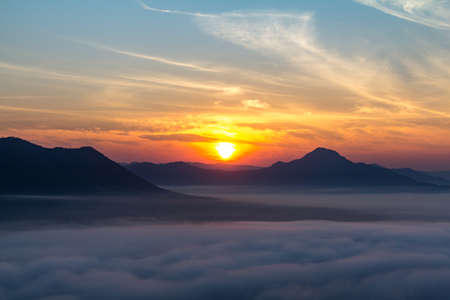 The morning sun with clouds. The fresh morning air, with the sun shining. Mist coveredの写真素材