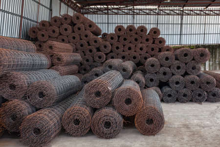 Rolls of wire mesh placed them in storage awaiting disposal. Steel Mesh is a structure for pouring concrete floorsの写真素材
